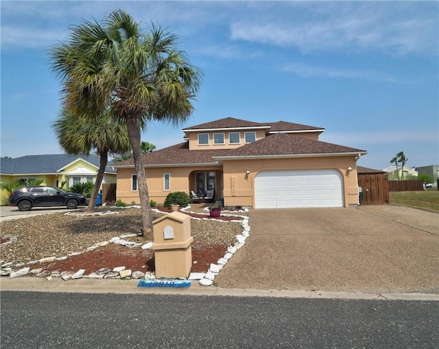 13810 Eaglesnest Bay Dr, Corpus Christi, TX 78418 - view of front facade featuring concrete driveway, stucco siding, an attached garage, and a shingled roof