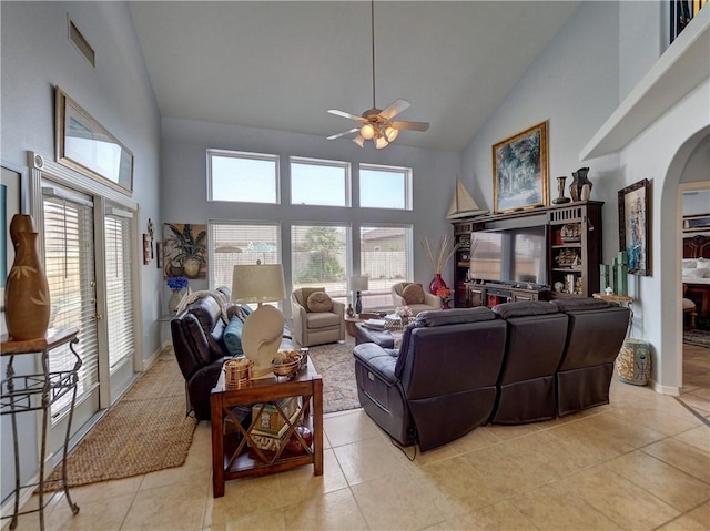13810 Eaglesnest Bay Dr, Corpus Christi, TX 78418 - living room with high vaulted ceiling, arched walkways, a ceiling fan, and light tile patterned floors