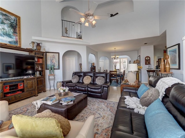 13810 Eaglesnest Bay Dr, Corpus Christi, TX 78418 - living room with arched walkways, high vaulted ceiling, light tile patterned flooring, a ceiling fan, and a chandelier