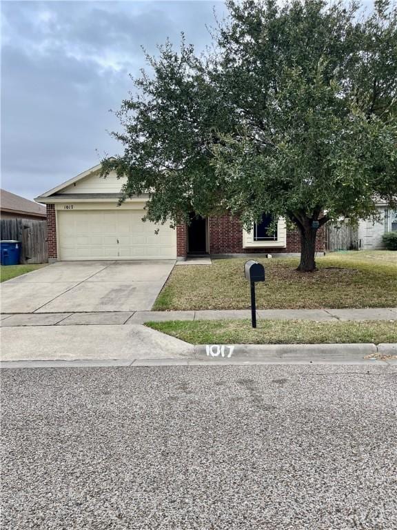 obstructed view of property featuring a garage and a front lawn