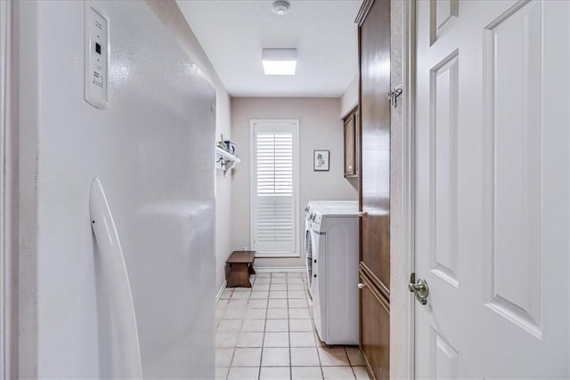 4217 Spring Creek Dr, Corpus Christi, TX 78410 - clothes washing area featuring baseboards, washer and clothes dryer, cabinet space, and light tile patterned floors