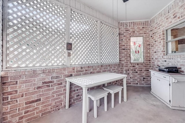 4217 Spring Creek Dr, Corpus Christi, TX 78410 - dining room with concrete flooring and brick wall