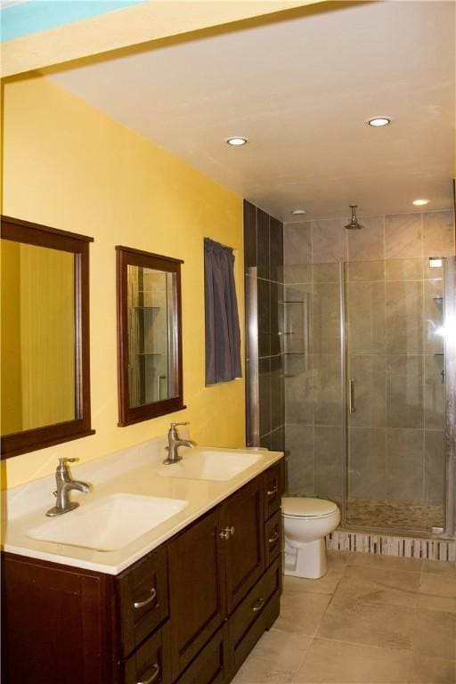 33 Encino Loma, Beeville, TX 78102 - bathroom featuring double vanity, a stall shower, tile patterned flooring, and recessed lighting