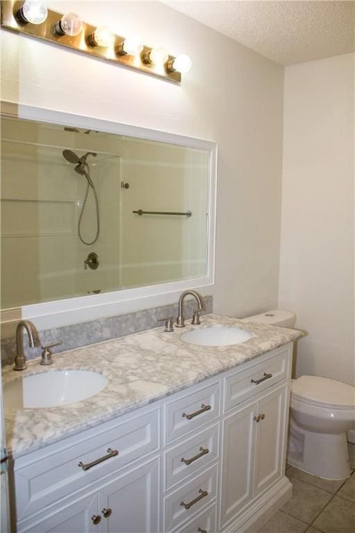 33 Encino Loma, Beeville, TX 78102 - full bathroom with double vanity, shower / bathtub combination, tile patterned flooring, and a textured ceiling