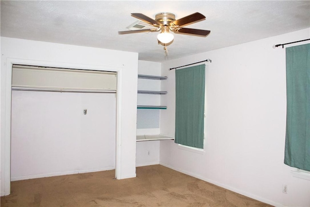 33 Encino Loma, Beeville, TX 78102 - unfurnished bedroom with carpet, a closet, and a ceiling fan