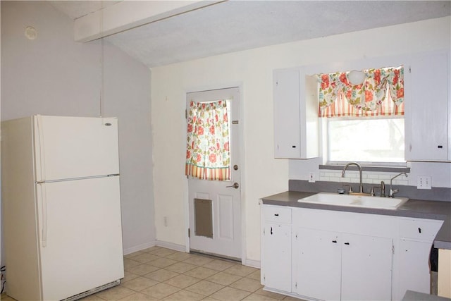 33 Encino Loma, Beeville, TX 78102 - kitchen featuring freestanding refrigerator, white cabinets, and dark countertops