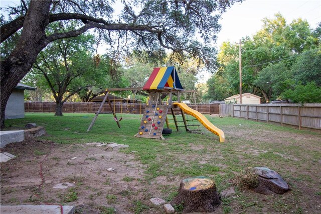 33 Encino Loma, Beeville, TX 78102 - fenced backyard with a playground