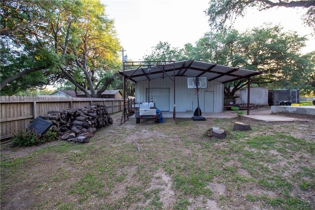 33 Encino Loma, Beeville, TX 78102 - rear view of property with an outdoor structure and a garage