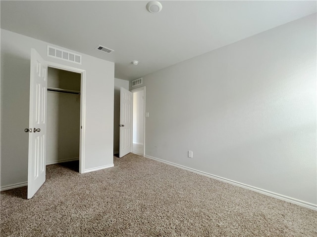 unfurnished bedroom with carpet floors and a closet