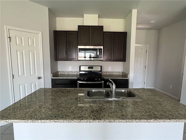 kitchen with a kitchen island with sink, appliances with stainless steel finishes, and sink