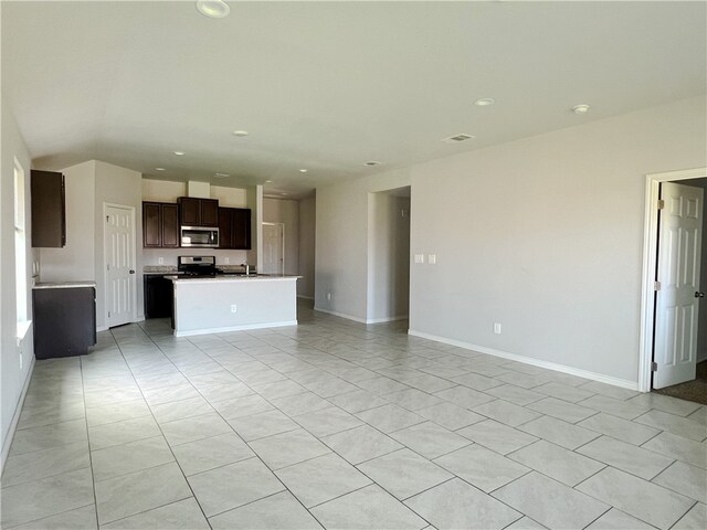 unfurnished living room featuring light tile patterned floors