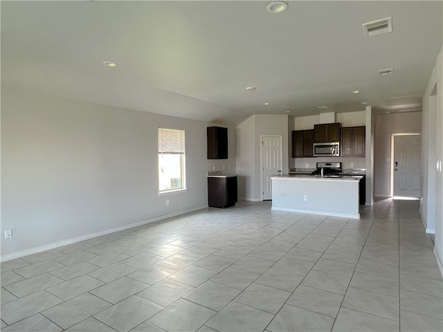 unfurnished living room featuring light tile patterned floors