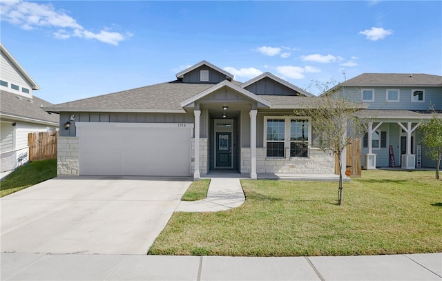 view of front of property with a front yard, a garage, and central AC unit