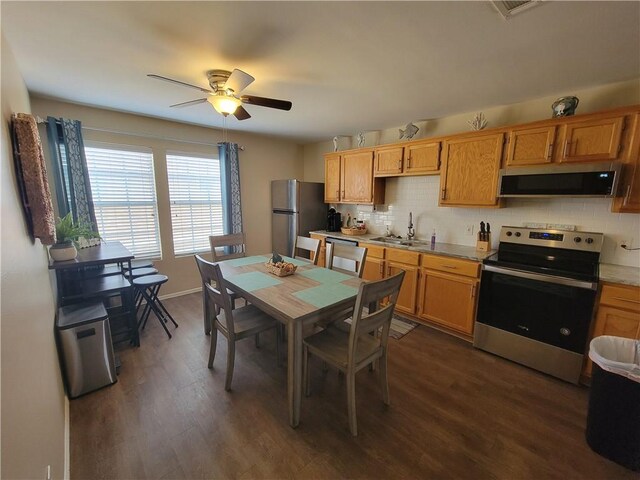 dining space with visible vents, baseboards, dark wood-type flooring, and ceiling fan