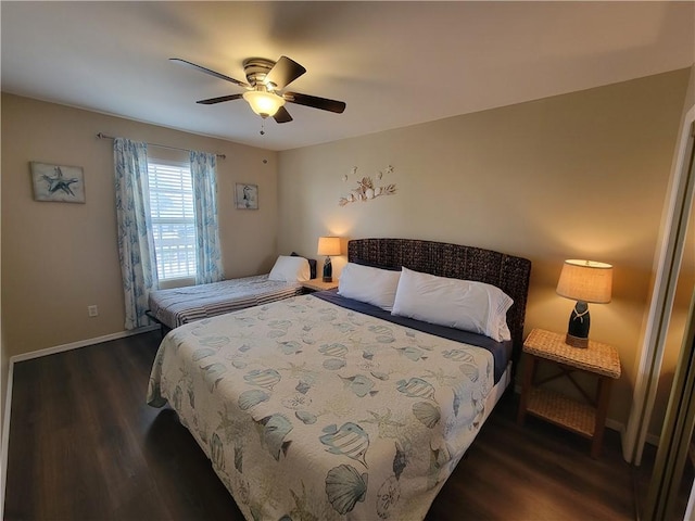 bedroom featuring ceiling fan, baseboards, and wood finished floors