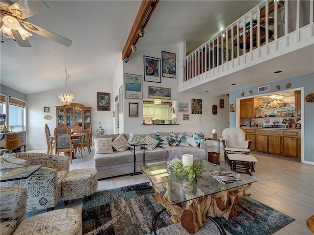 living room featuring ceiling fan with notable chandelier, light hardwood / wood-style flooring, high vaulted ceiling, and track lighting