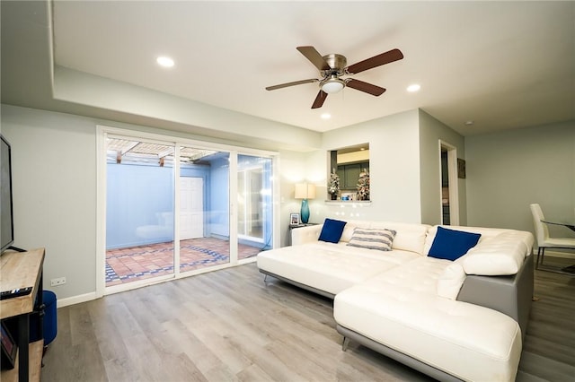 living room with light wood-type flooring and ceiling fan