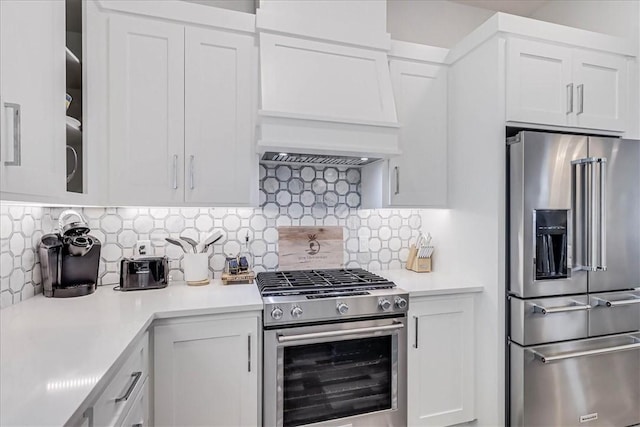 4885 S State Highway 361st St Unit H, Port Aransas, TX 78373 - kitchen featuring appliances with stainless steel finishes, light countertops, white cabinetry, glass insert cabinets, and backsplash
