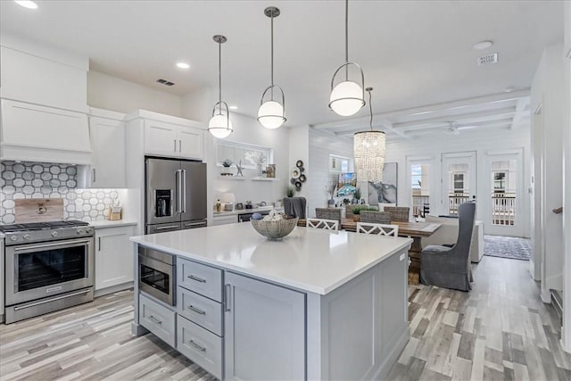 4885 S State Highway 361st St Unit H, Port Aransas, TX 78373 - kitchen with appliances with stainless steel finishes, light wood finished floors, light countertops, decorative backsplash, and recessed lighting