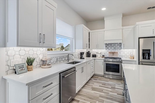 4885 S State Highway 361st St Unit H, Port Aransas, TX 78373 - kitchen featuring appliances with stainless steel finishes, light countertops, white cabinetry, decorative backsplash, and recessed lighting