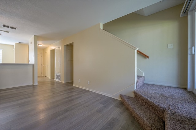 interior space with hardwood / wood-style floors and a textured ceiling