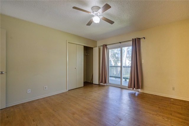 unfurnished bedroom with ceiling fan, a closet, access to outside, and light hardwood / wood-style flooring