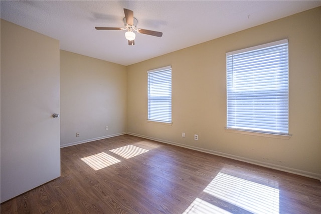 unfurnished room with wood-type flooring, ceiling fan, and a healthy amount of sunlight