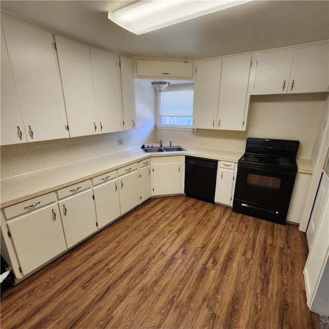 kitchen featuring black appliances, white cabinetry, and light countertops