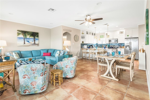 living room featuring ornamental molding, ceiling fan, and light tile patterned floors