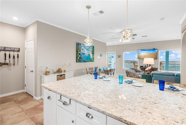 664 Kara Prt, Aransas, TX 78373 - kitchen featuring ornamental molding, white cabinets, light stone countertops, ceiling fan, and baseboards