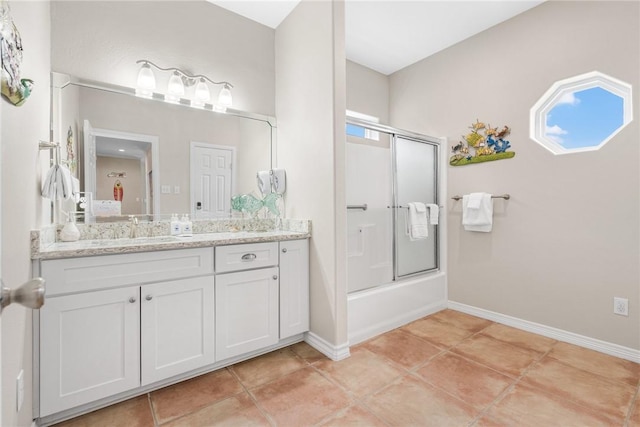 664 Kara Prt, Aransas, TX 78373 - full bath featuring vanity, tile patterned floors, bath / shower combo with glass door, and baseboards