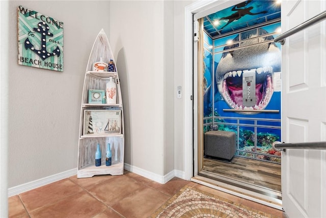 664 Kara Prt, Aransas, TX 78373 - corridor with baseboards and tile patterned flooring