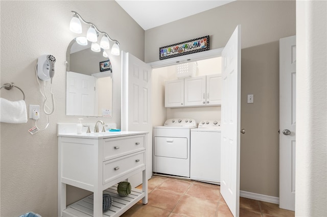 bathroom with washing machine and dryer, vanity, and tile patterned floors