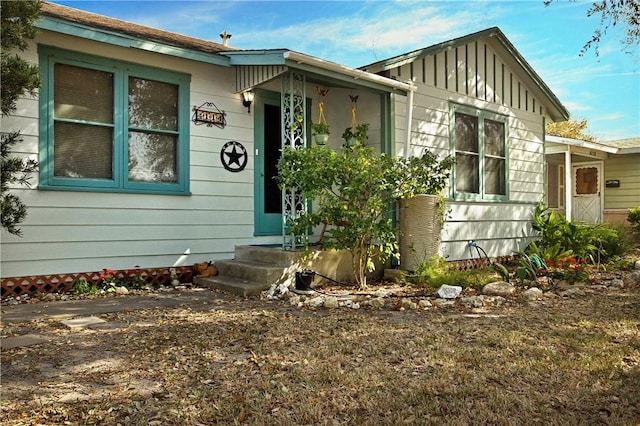 ranch-style house with driveway, a garage, fence, and board and batten siding