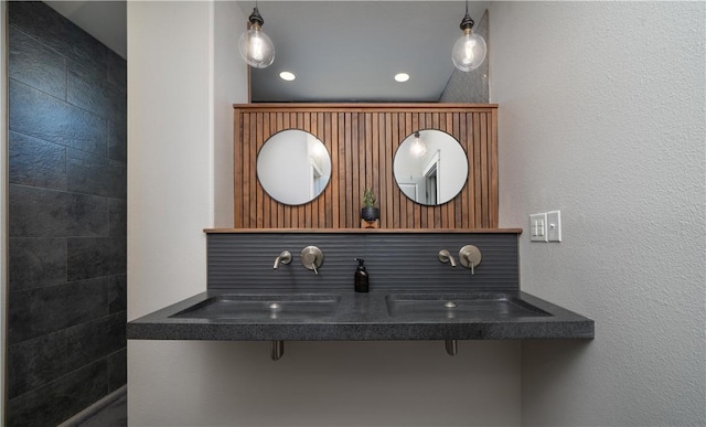bathroom with a sink and a textured wall