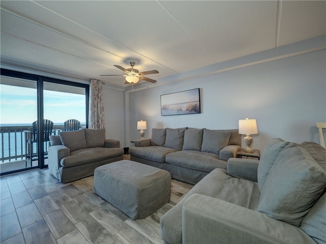 living room featuring a water view and ceiling fan