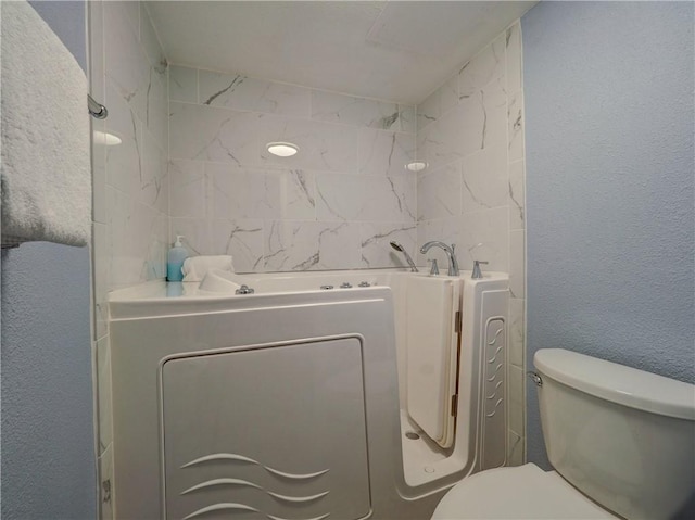 6109 State Highway 361 Unit 1101, Port Aransas, TX 78373 - full bath with toilet, a textured wall, and a bath