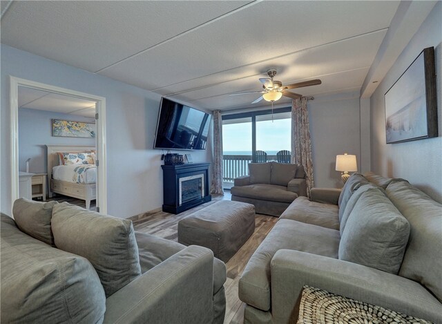 living room with ceiling fan and light hardwood / wood-style floors