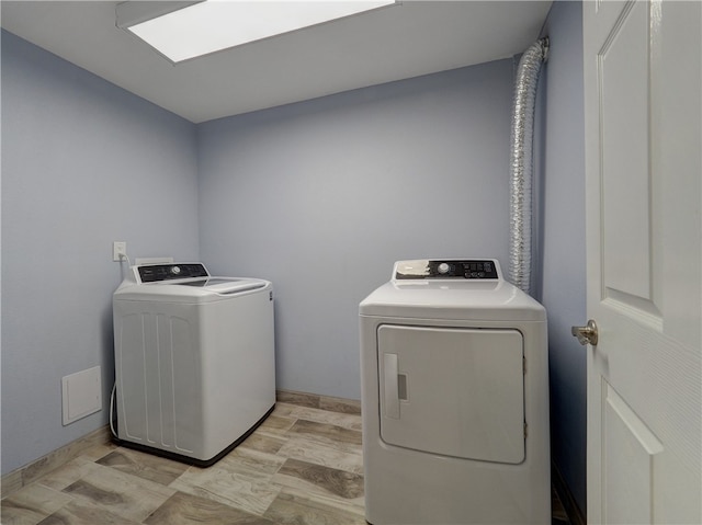 washroom with light hardwood / wood-style floors and independent washer and dryer