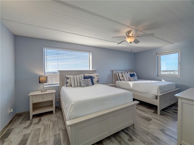 bedroom featuring ceiling fan and light hardwood / wood-style flooring