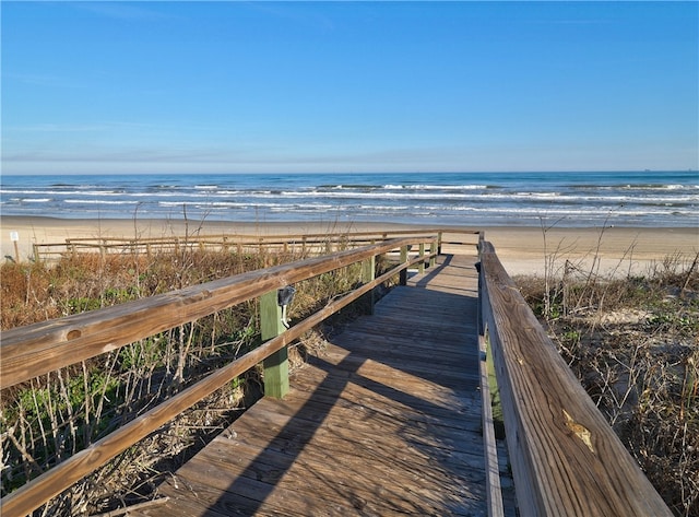 view of property's community with a beach view and a water view