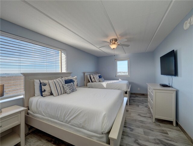 bedroom featuring light hardwood / wood-style floors and ceiling fan