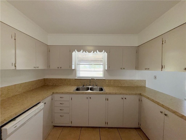 kitchen featuring dishwasher, light tile patterned floors, light countertops, and a sink