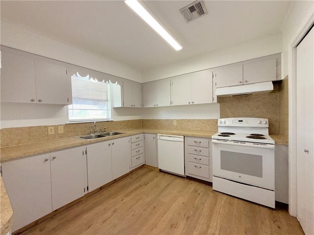 kitchen featuring visible vents, a sink, light wood-type flooring, white appliances, and under cabinet range hood