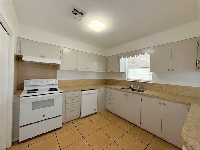 kitchen with white appliances, visible vents, light countertops, under cabinet range hood, and a sink
