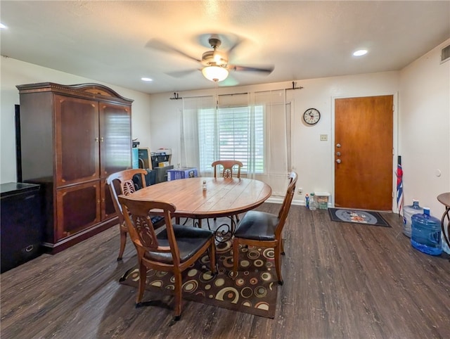 dining room with ceiling fan and dark hardwood / wood-style flooring