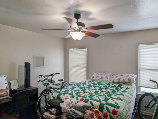 bedroom with a textured ceiling and ceiling fan