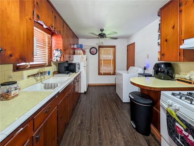 kitchen with tile countertops, decorative backsplash, dark wood-type flooring, and sink