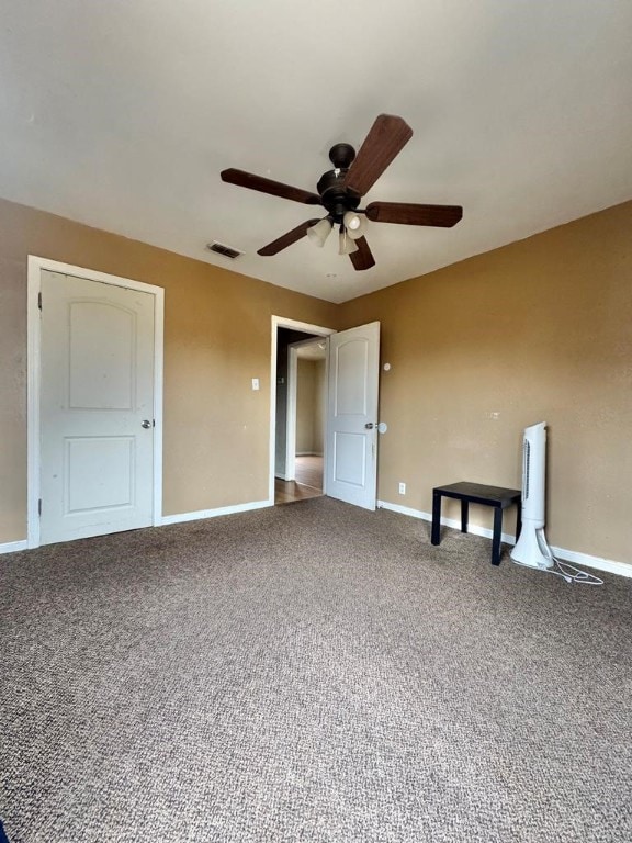 unfurnished bedroom with carpet, visible vents, and baseboards