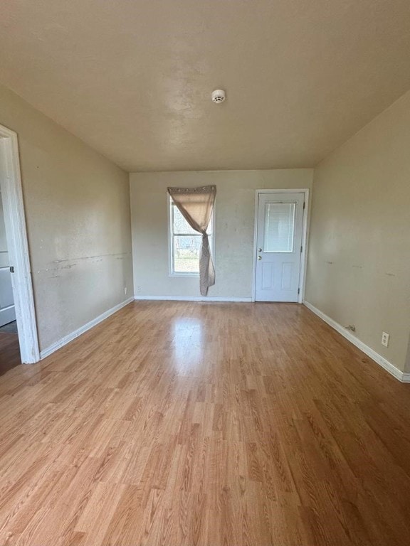 unfurnished room featuring light wood-style flooring and baseboards